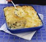 Fish pie in a large rectangular dish with serving spoon