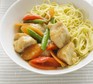 Bowl of lemon chicken chunks with vegetables and noodles